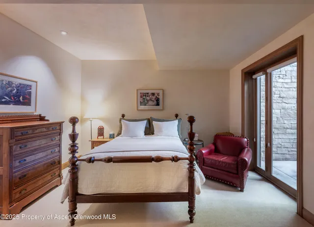 a bedroom with furniture and a window