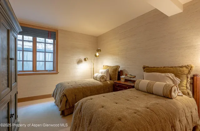 a bedroom with two beds and a night stand