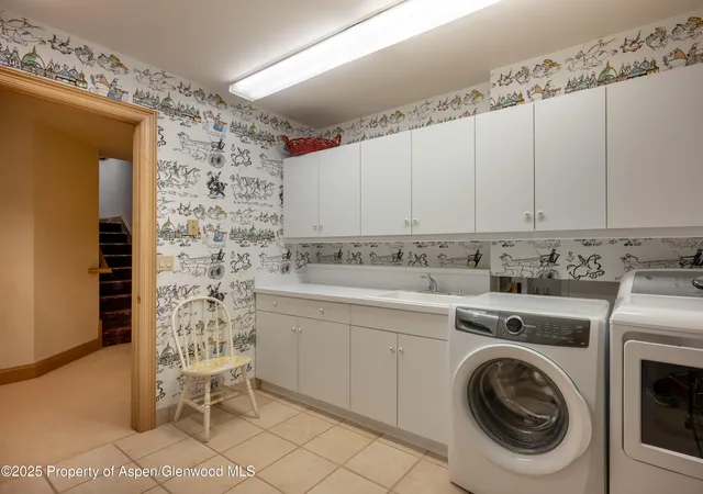a utility room with sink dryer and washer