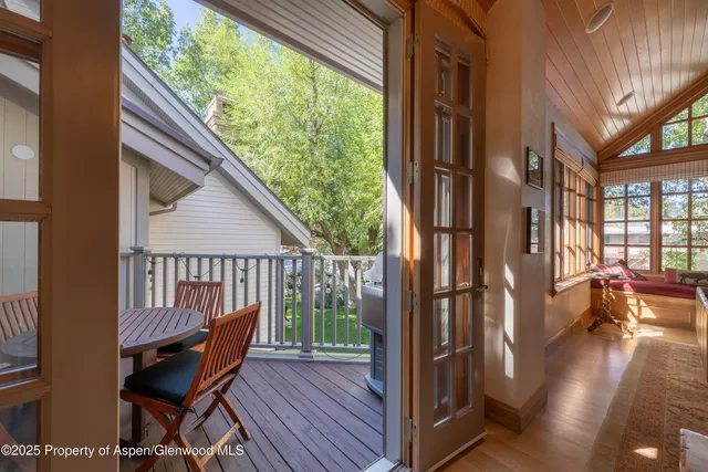 a view of balcony with furniture and wooden floor