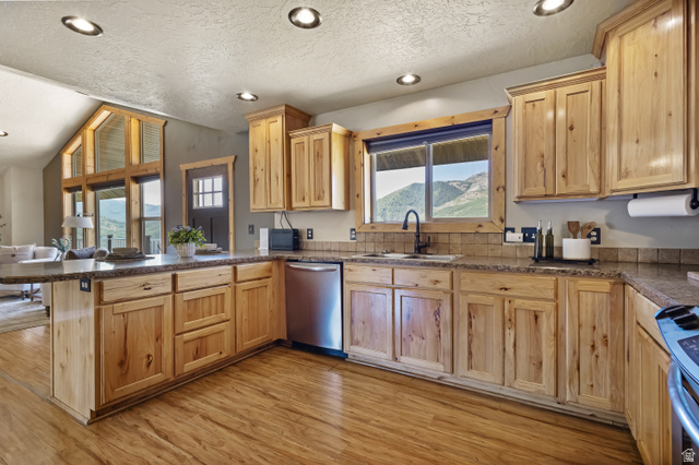 2013 North River View Road Huntsville, UT 84317 - Photo 14 of 53 Kitchen with a peninsula, light wood finish cabinetry, stainless steel appliances, recessed lighting, and light wood-style floors