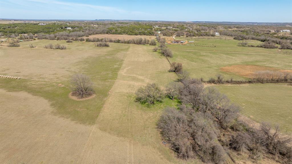 2290 North N Farm Rainbow, TX 76077 - Photo 13 of 22 Aerial view of sparsely populated area with a tree filled landscape