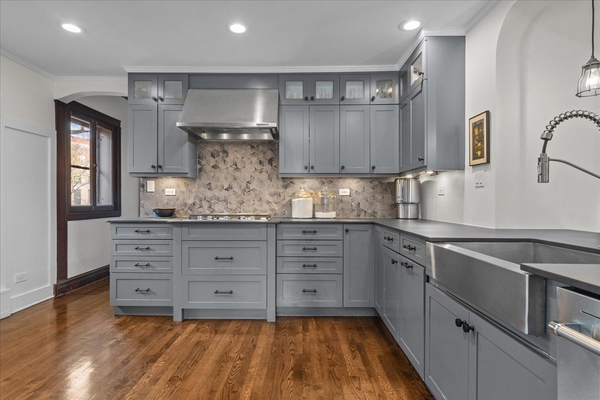 2087 West Greenleaf Avenue Chicago, IL 60645 - Photo 16 of 35 a kitchen with granite countertop white cabinets and white appliances