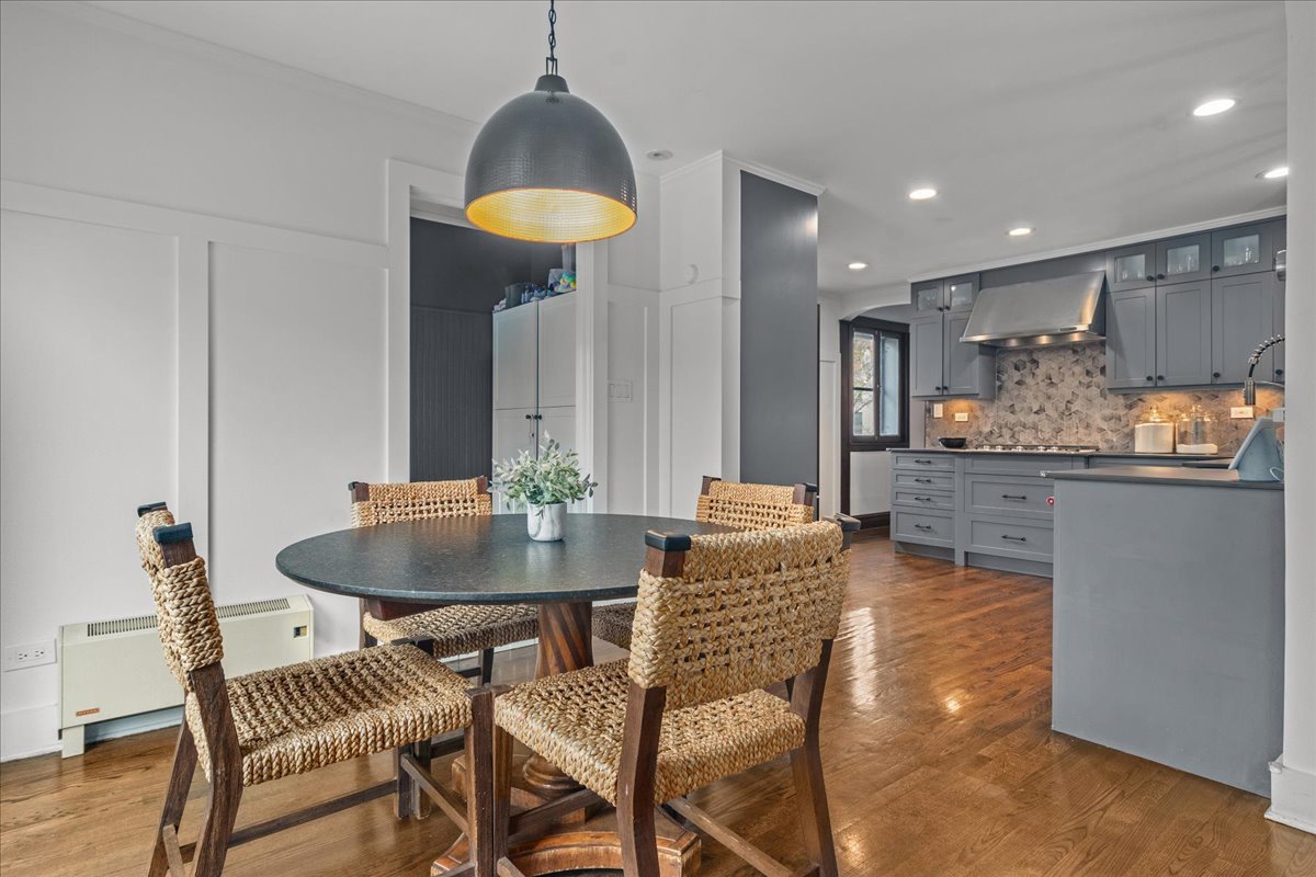 2087 West Greenleaf Avenue Chicago, IL 60645 - Photo 21 of 35 a dining room with furniture and a chandelier