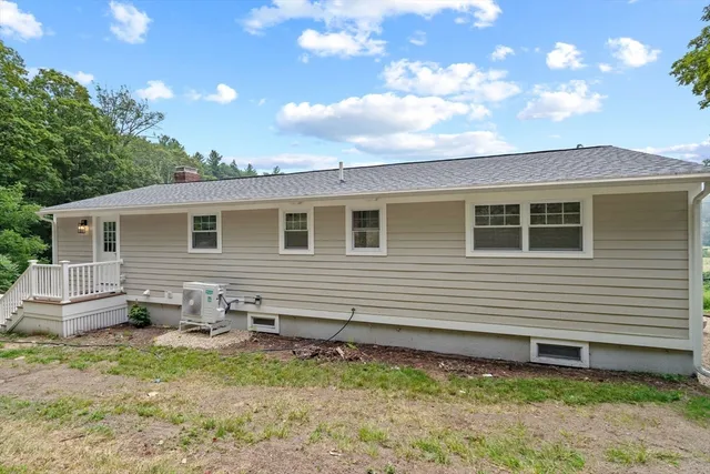 a backyard of a house with table and chairs