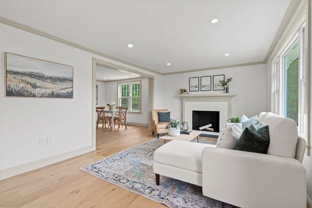 a living room with furniture a fireplace and a table