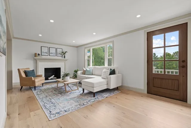 a living room with furniture large window and a fireplace