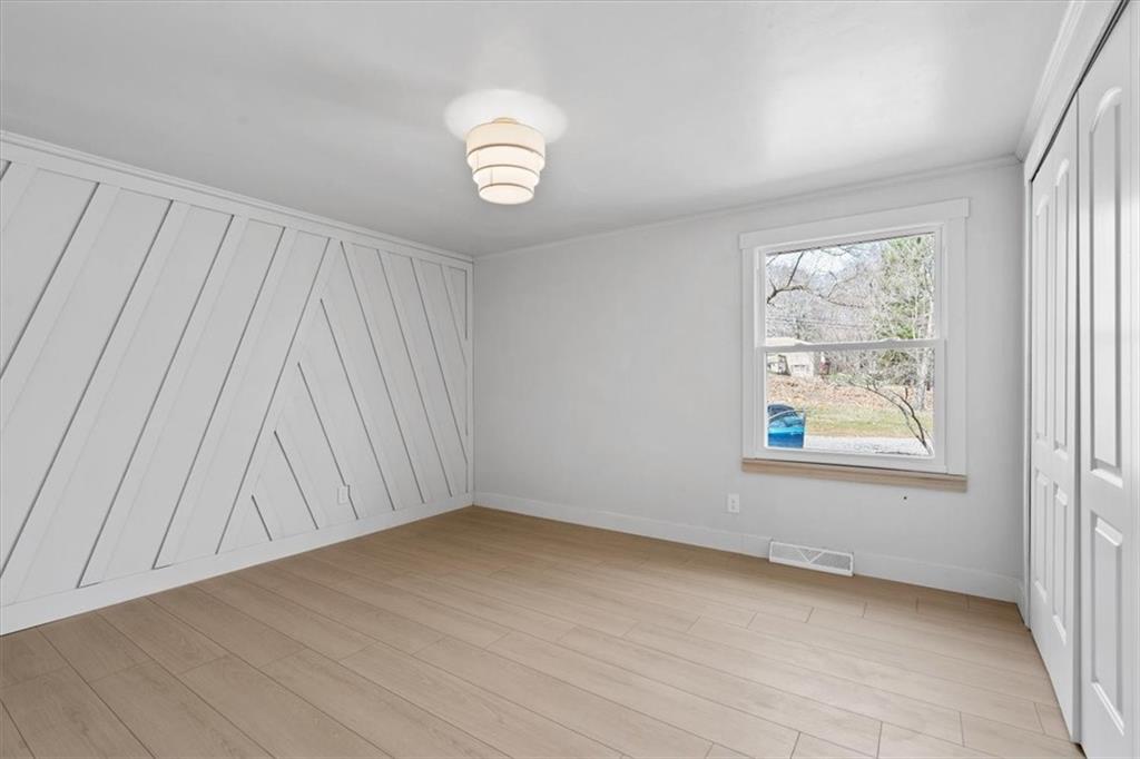 319 Gringo Independence Road Aliquippa, PA 15001 - Photo 15 of 25 an empty room with wooden floor and windows