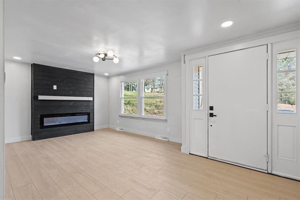 319 Gringo Independence Road Aliquippa, PA 15001 - Photo 4 of 25 a view of an empty room with a window and a kitchen