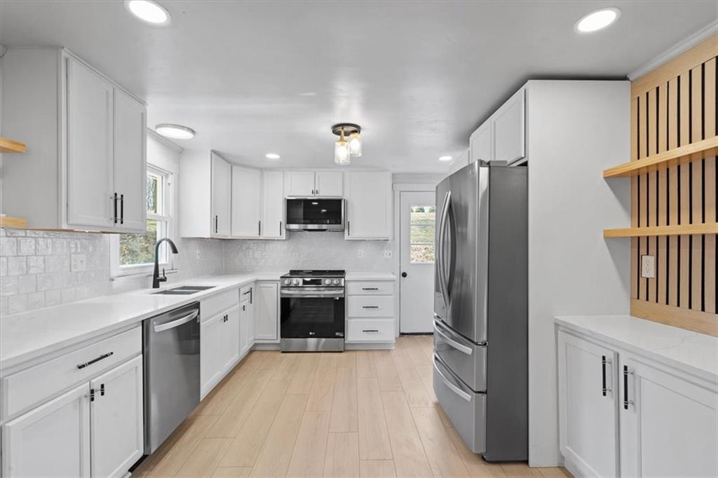 319 Gringo Independence Road Aliquippa, PA 15001 - Photo 6 of 25 a kitchen with stainless steel appliances granite countertop a refrigerator sink and stove
