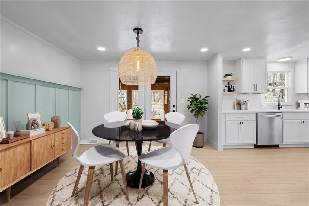 319 Gringo Independence Road Aliquippa, PA 15001 - Photo 8 of 25 a living room with furniture a chandelier and a dining table with wooden floor