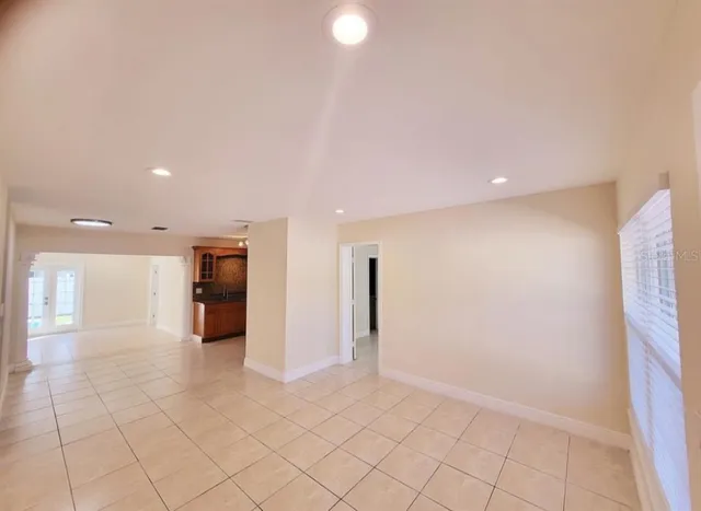 an empty room with white walls and tiles