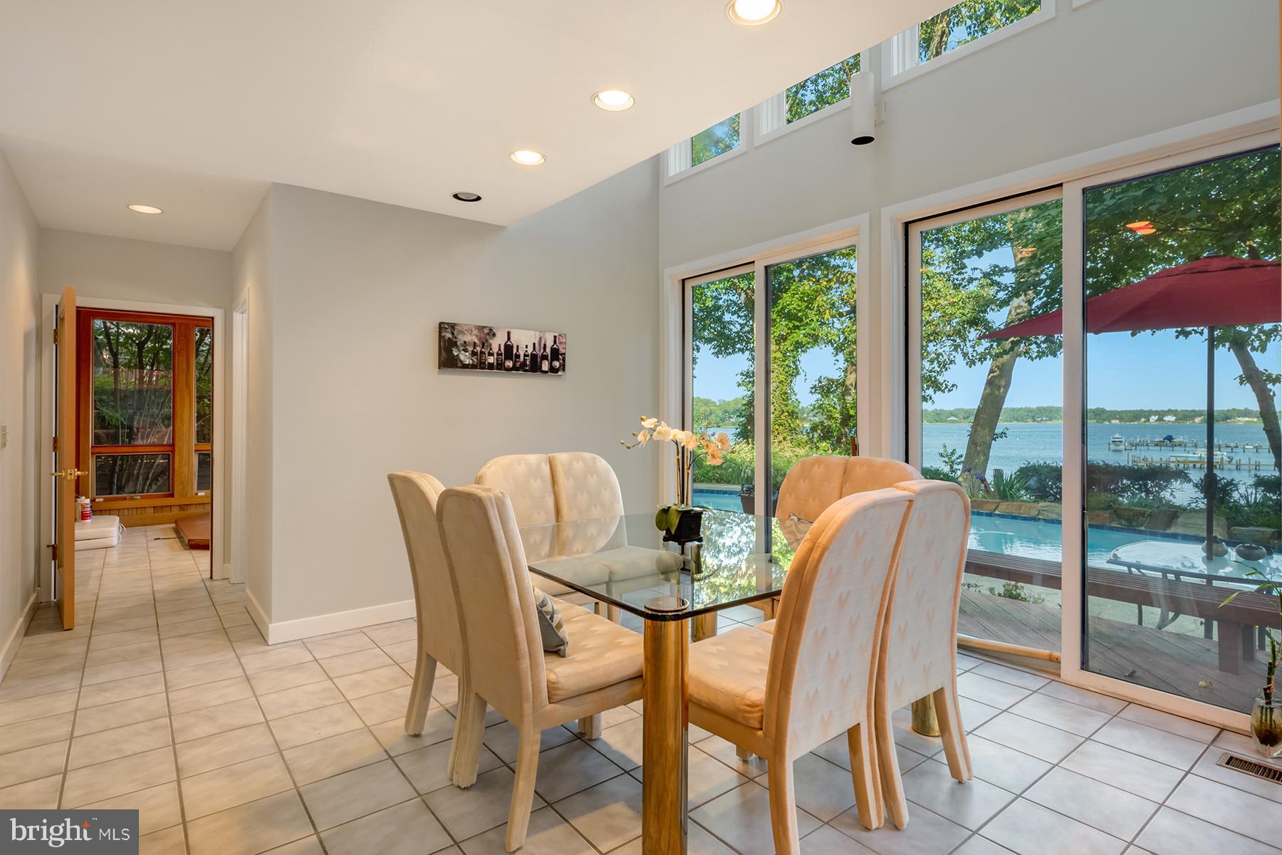 65 Slama Road Edgewater, MD 21037 - Photo 8 of 27 Dining area has two-story wall of windows