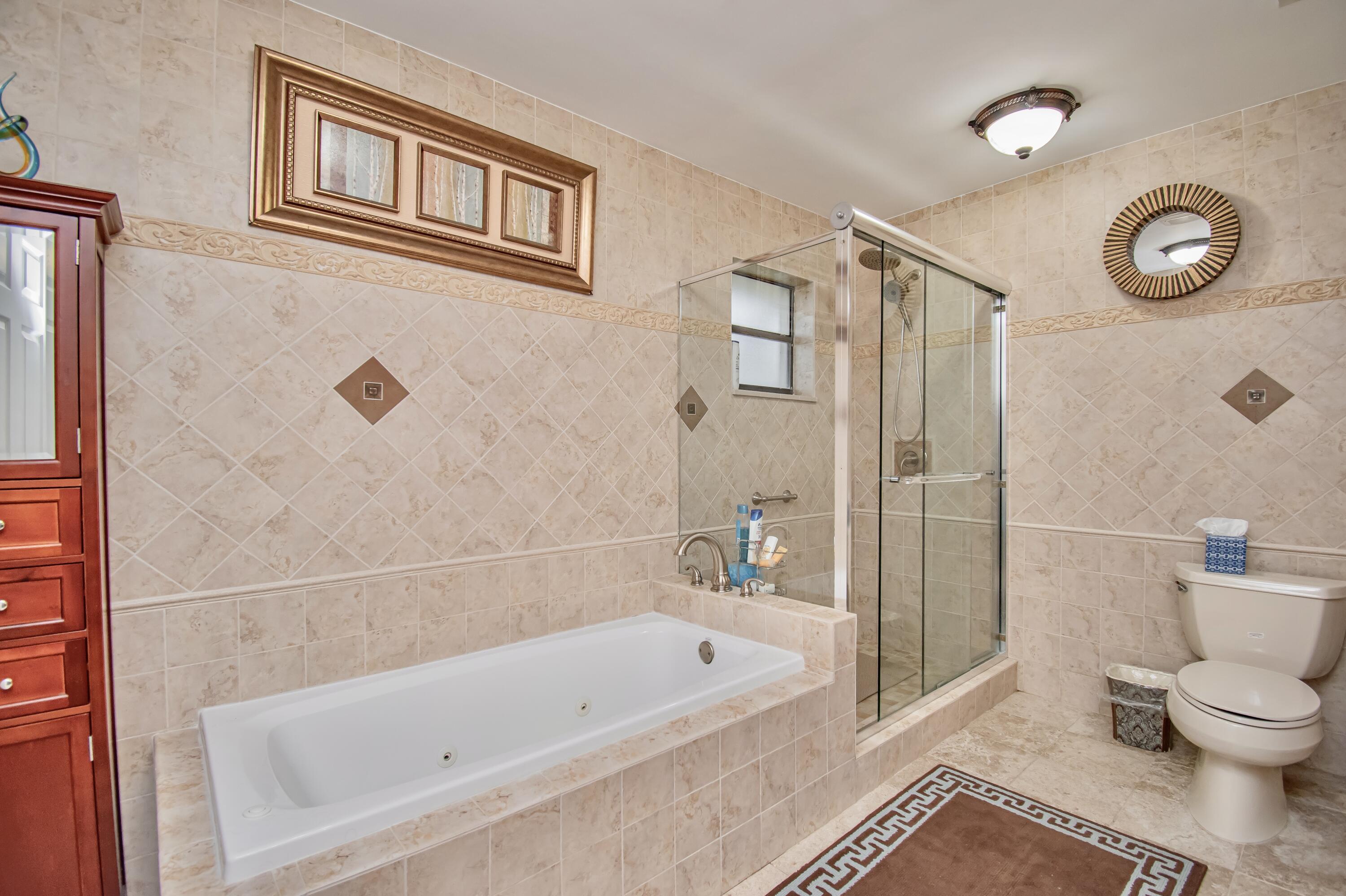 7838 Cypress Crescent Boca Raton, FL 33433 - Photo 15 of 24 a bathroom with a bathtub and a shower