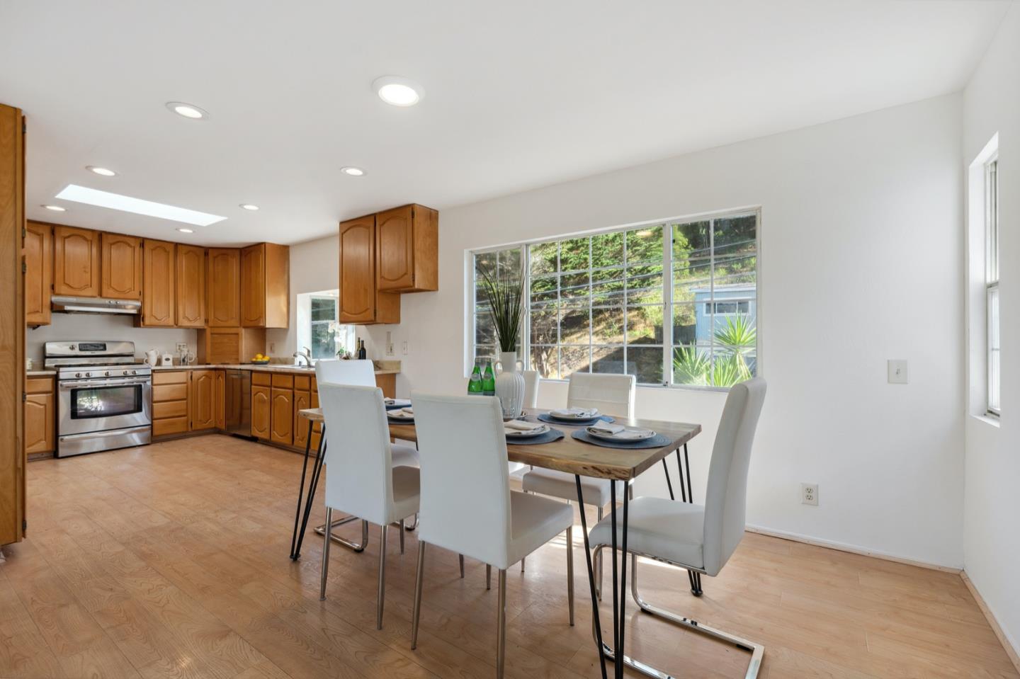 1060 Crespi Drive Pacifica, CA 94044 - Photo 12 of 32 a kitchen with a table chairs refrigerator and cabinets