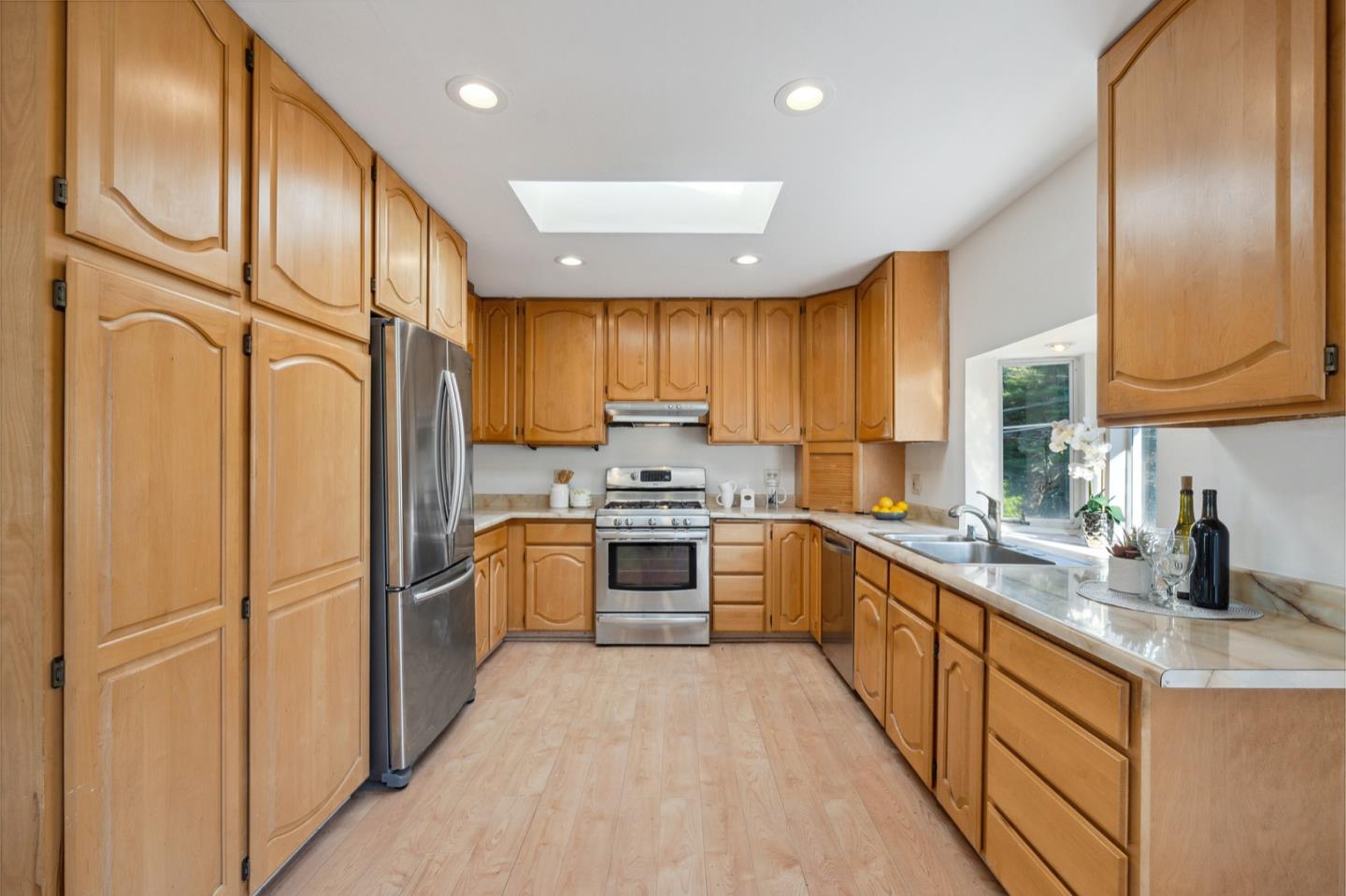 1060 Crespi Drive Pacifica, CA 94044 - Photo 14 of 32 a kitchen with stainless steel appliances granite countertop a refrigerator a sink dishwasher a stove with wooden cabinets and floor