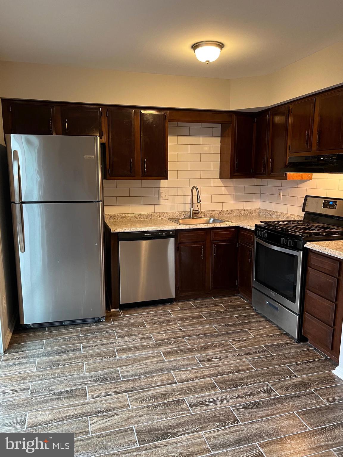 68 Hopewell Lane, Unit B Sicklerville, NJ 08081 - Photo 6 of 14 a kitchen with stainless steel appliances granite countertop a refrigerator and a sink