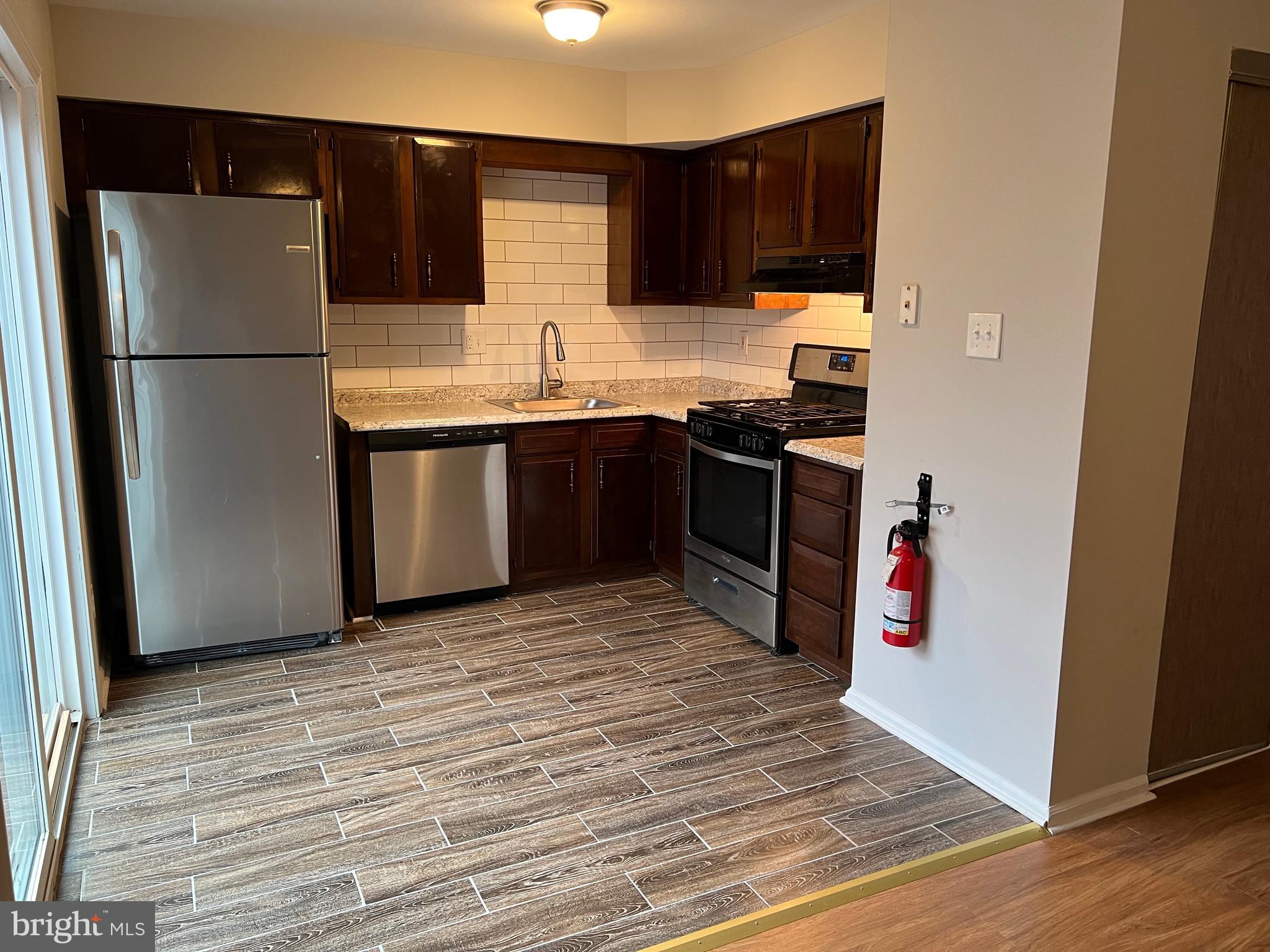 68 Hopewell Lane, Unit B Sicklerville, NJ 08081 - Photo 7 of 14 a kitchen with granite countertop a refrigerator and a stove