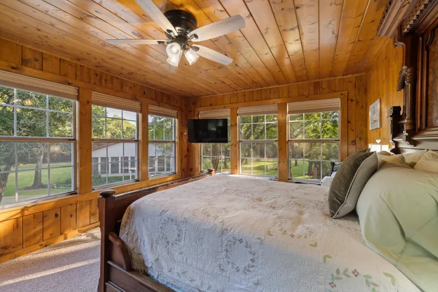 a view of a patio with couches table and chairs and potted plants