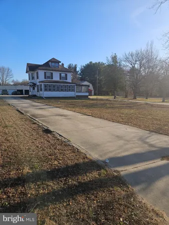 a view of a big house with a yard
