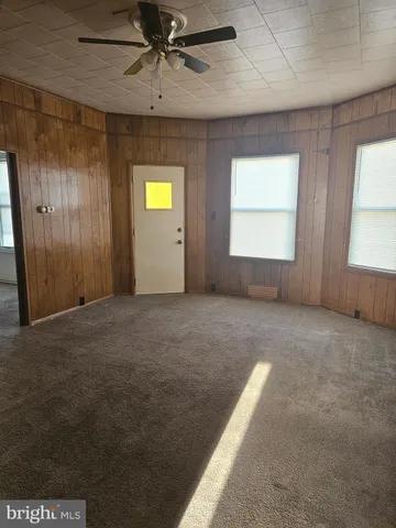 an empty room with windows and entrance