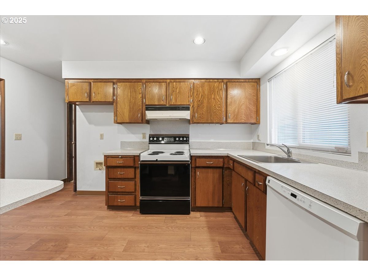 6760 Southwest 199th Court Beaverton, OR 97078 - Photo 13 of 44 a kitchen with stainless steel appliances a stove and more cabinets