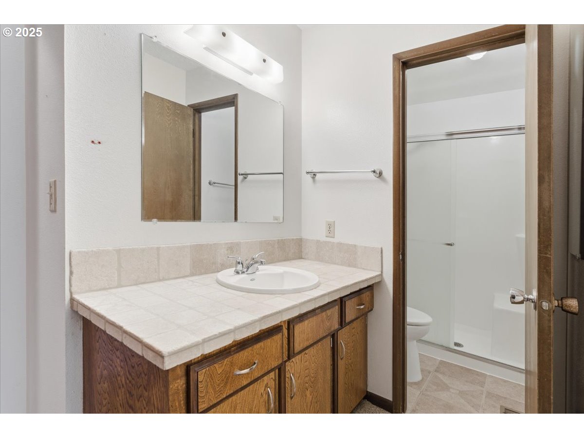 6760 Southwest 199th Court Beaverton, OR 97078 - Photo 19 of 44 a bathroom with a sink vanity and a mirror