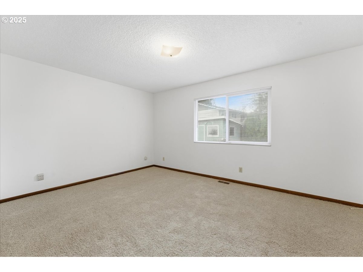 6760 Southwest 199th Court Beaverton, OR 97078 - Photo 21 of 44 a view of an empty room with a window
