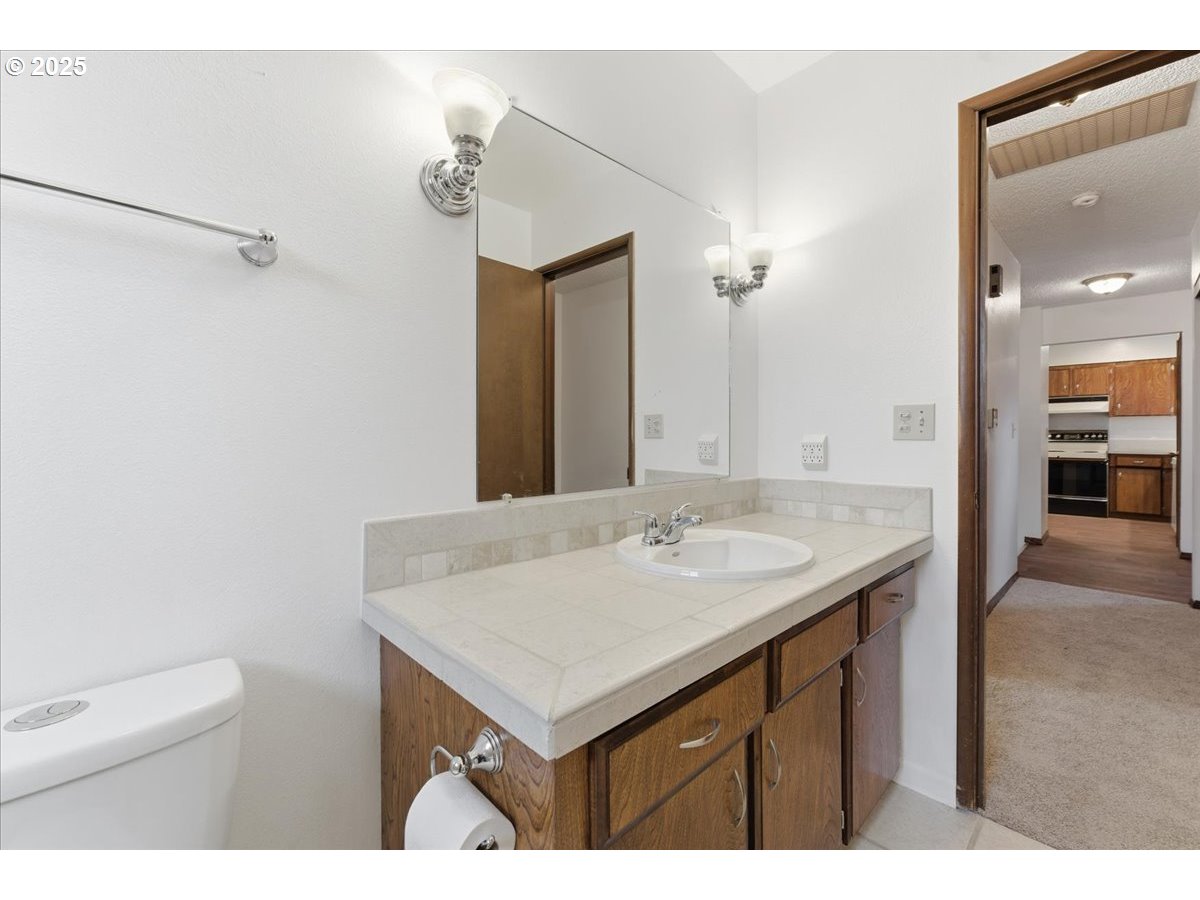6760 Southwest 199th Court Beaverton, OR 97078 - Photo 30 of 44 a bathroom with a sink vanity and a mirror