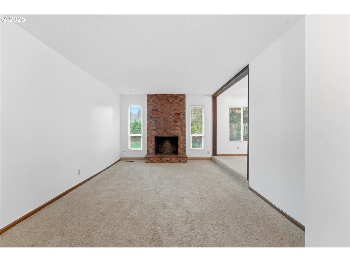 6760 Southwest 199th Court Beaverton, OR 97078 - Photo 4 of 44 a view of an empty room with a fireplace