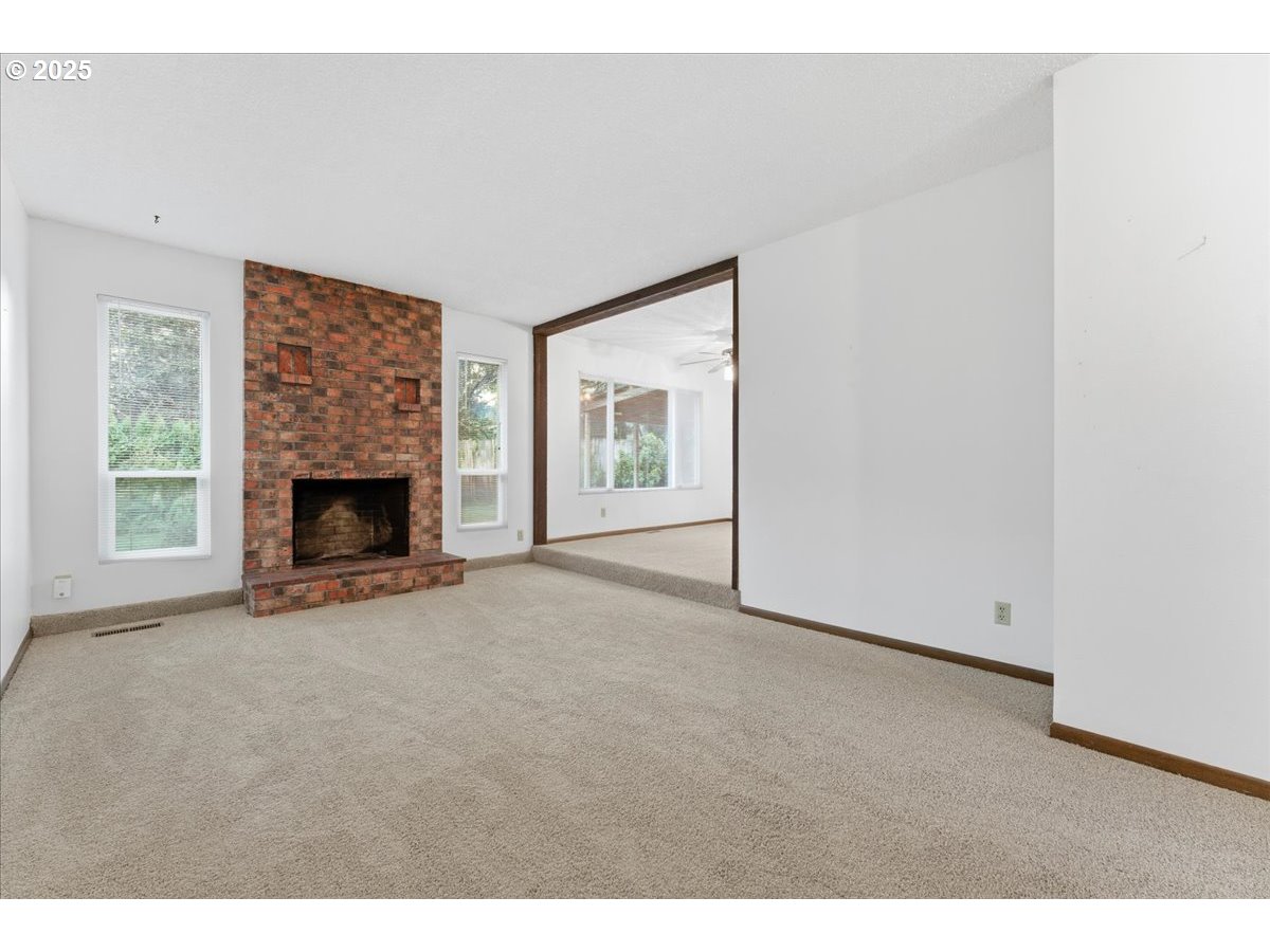 6760 Southwest 199th Court Beaverton, OR 97078 - Photo 5 of 44 a view of an empty room with window and fire place