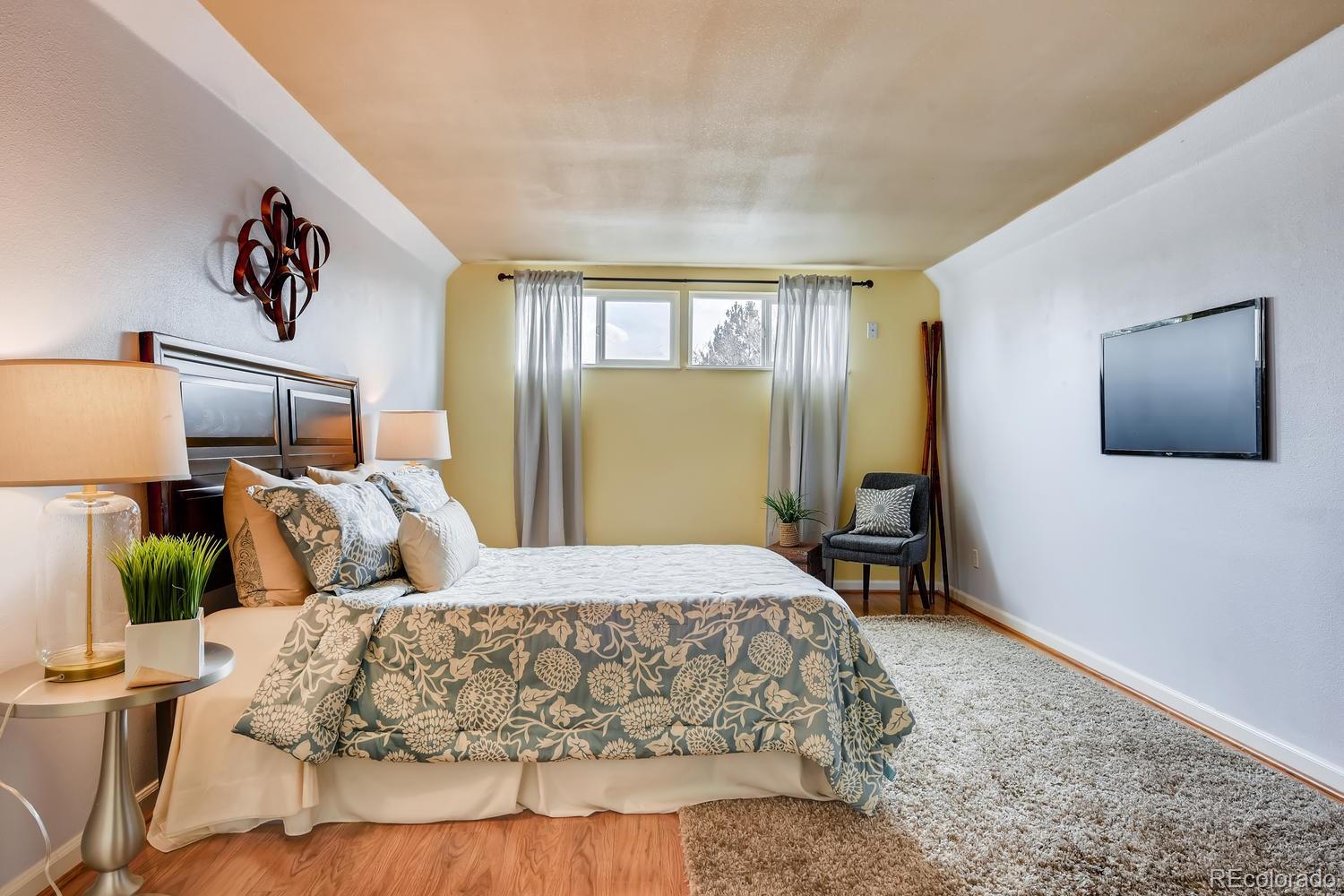 6734 Kendall Street Arvada, CO 80003 - Photo 17 of 36 a bedroom with a bed and window