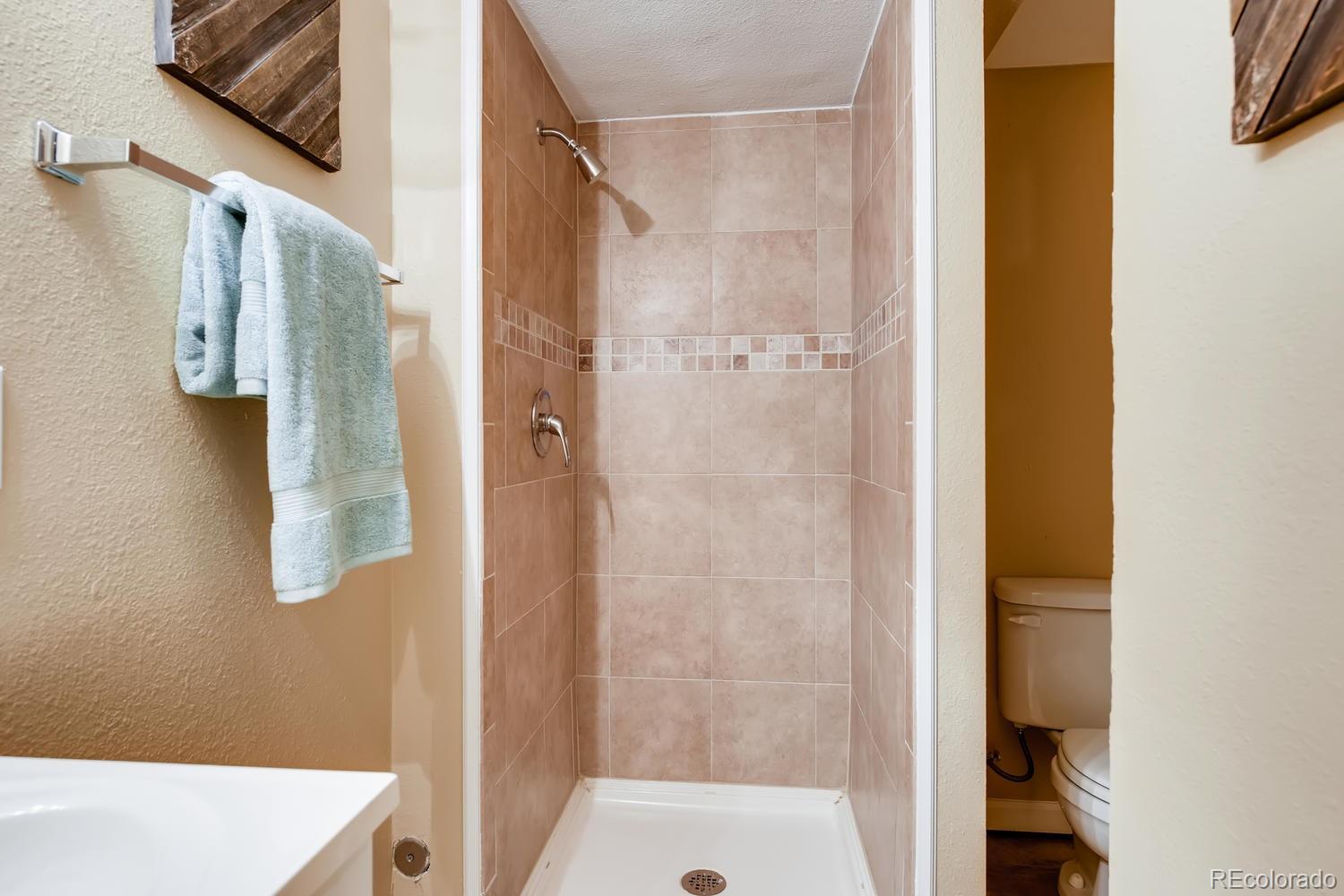 6734 Kendall Street Arvada, CO 80003 - Photo 23 of 36 a bathroom with a shower and a sink