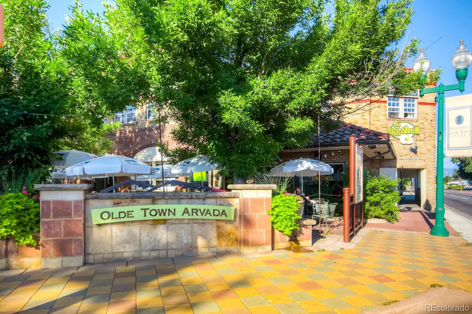 6734 Kendall Street Arvada, CO 80003 - Photo 30 of 36 a view of a patio with a table and chairs under an umbrella