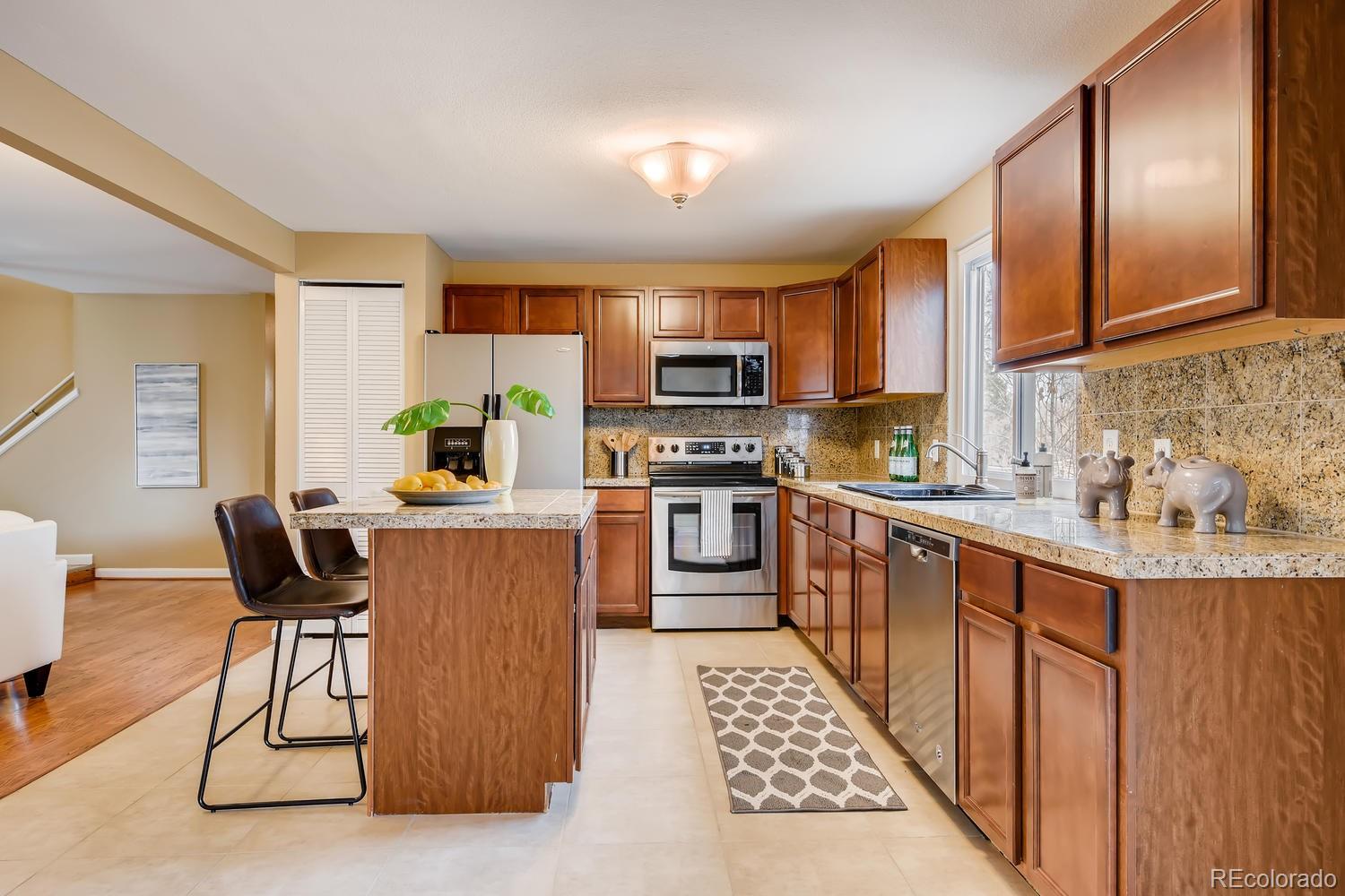 6734 Kendall Street Arvada, CO 80003 - Photo 3 of 36 a kitchen with a sink cabinets and window