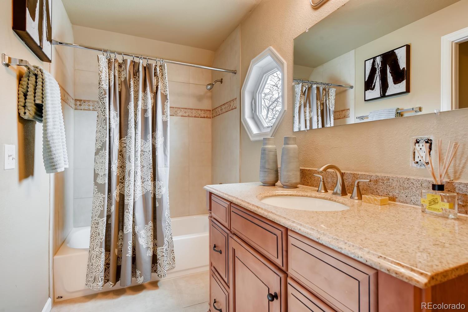6734 Kendall Street Arvada, CO 80003 - Photo 4 of 36 a bathroom with a sink and a mirror