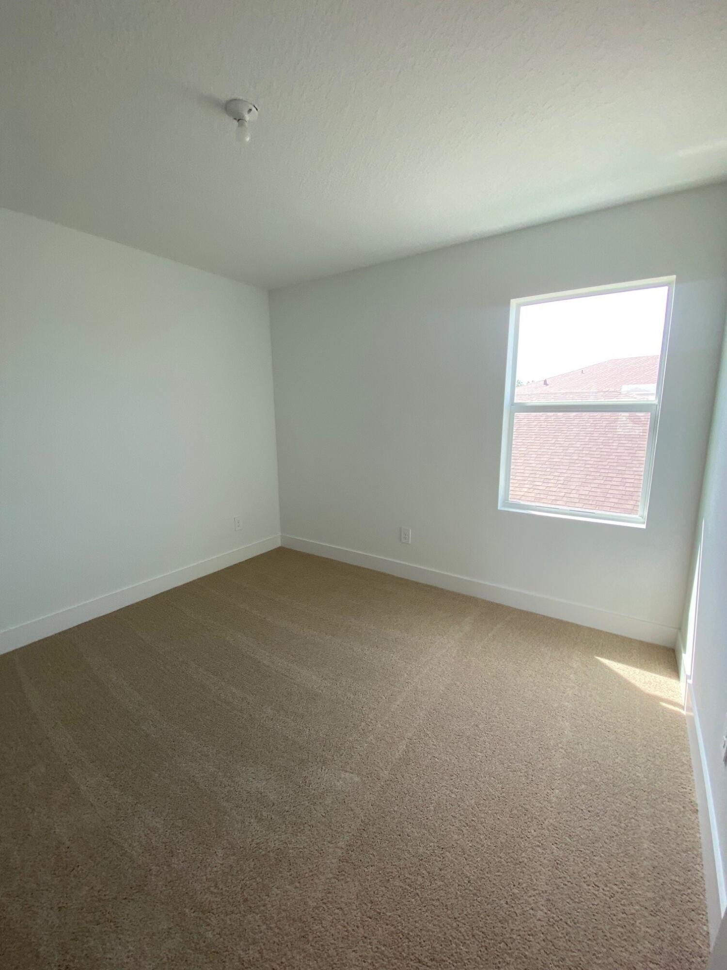 6830 Southeast Park Trace Drive Stuart, FL 34997 - Photo 11 of 20 an empty room with a window