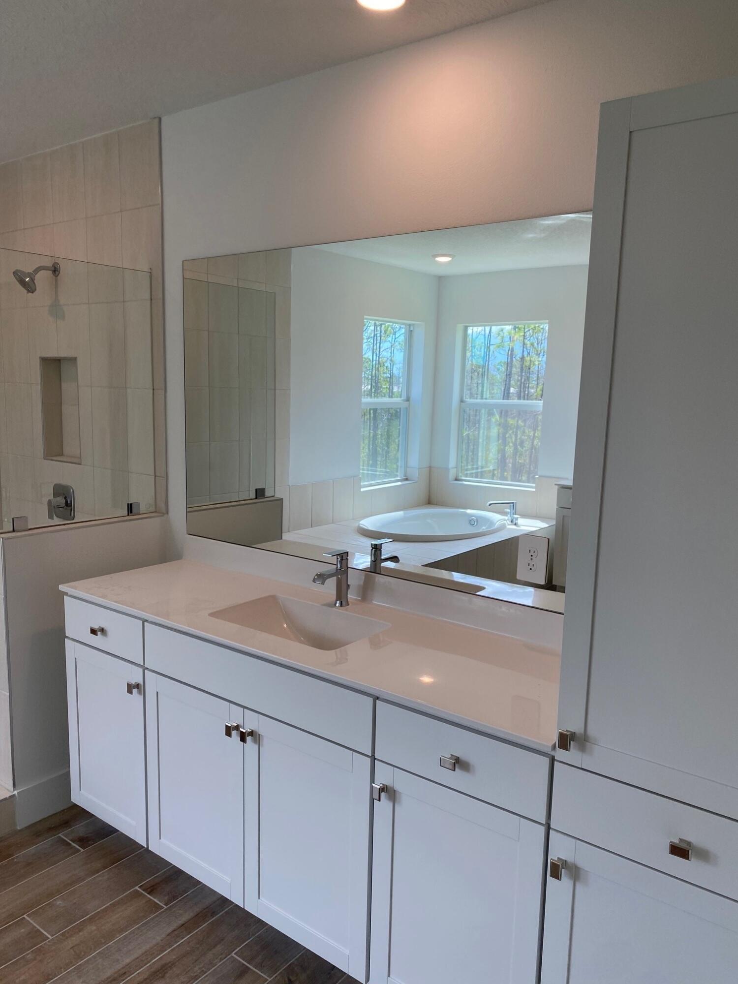 6830 Southeast Park Trace Drive Stuart, FL 34997 - Photo 14 of 20 a room with a sink and mirror