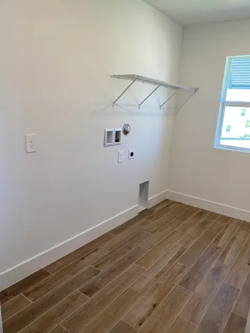 a view of a room with wooden floor and cabinets