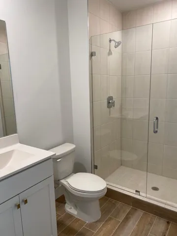 a bathroom with a toilet a sink and shower