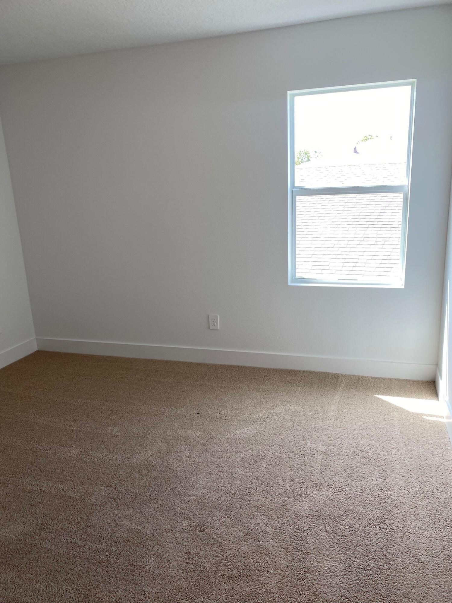 6830 Southeast Park Trace Drive Stuart, FL 34997 - Photo 10 of 20 an empty room with a window