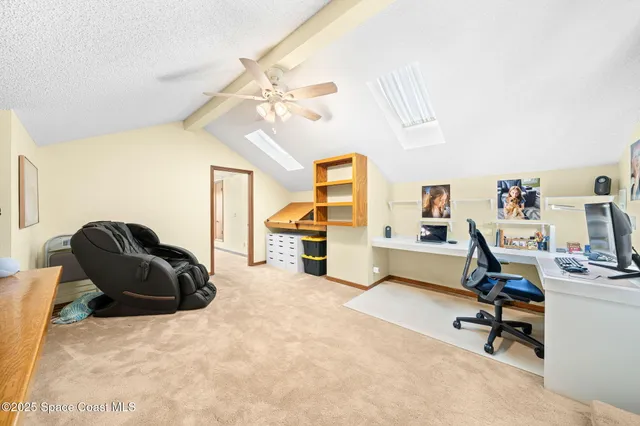 a view of a livingroom with workspace and a window