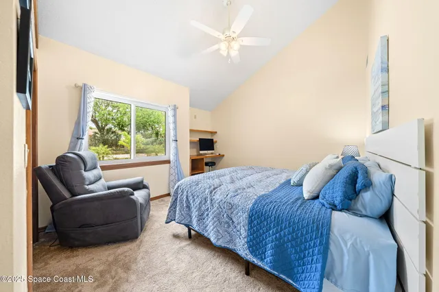 a bedroom with a bed and a couch