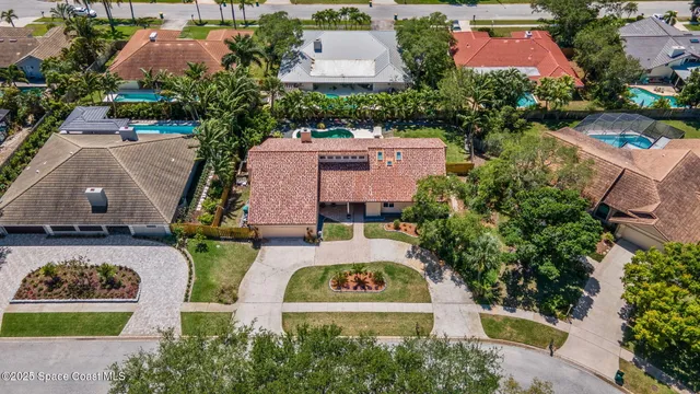 an aerial view of a house with a garden and swimming pool