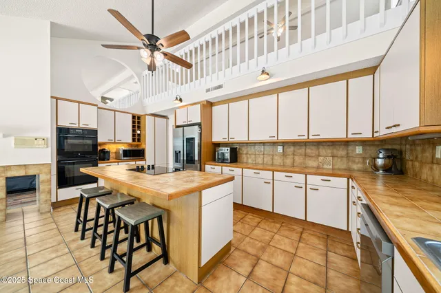 a kitchen with stainless steel appliances granite countertop a stove and cabinets