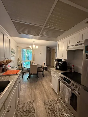 a kitchen with stainless steel appliances a stove a sink and a refrigerator