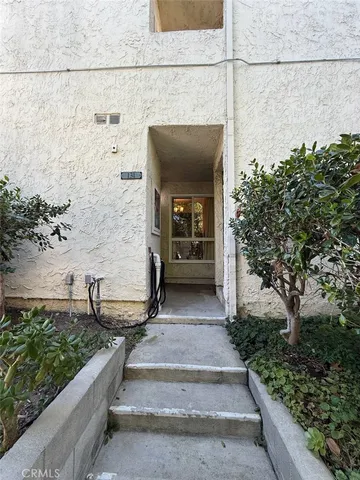 a view of a house with pool and chairs