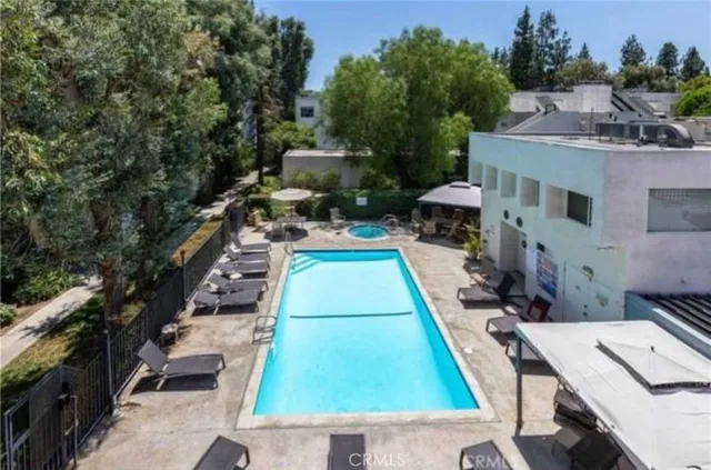 a swimming pool with outdoor seating and yard