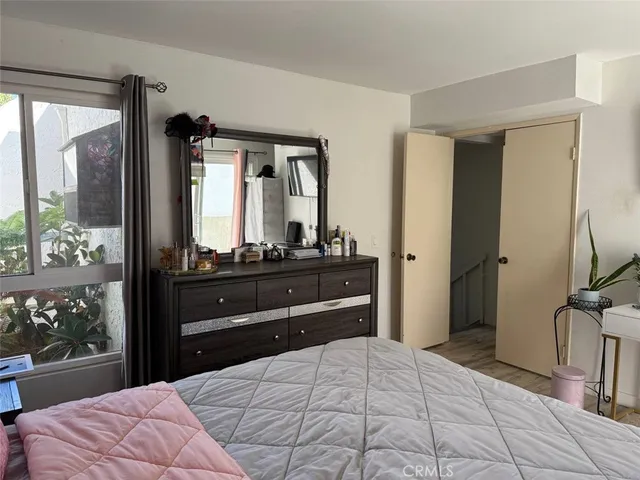 a bedroom with a bed and large windows