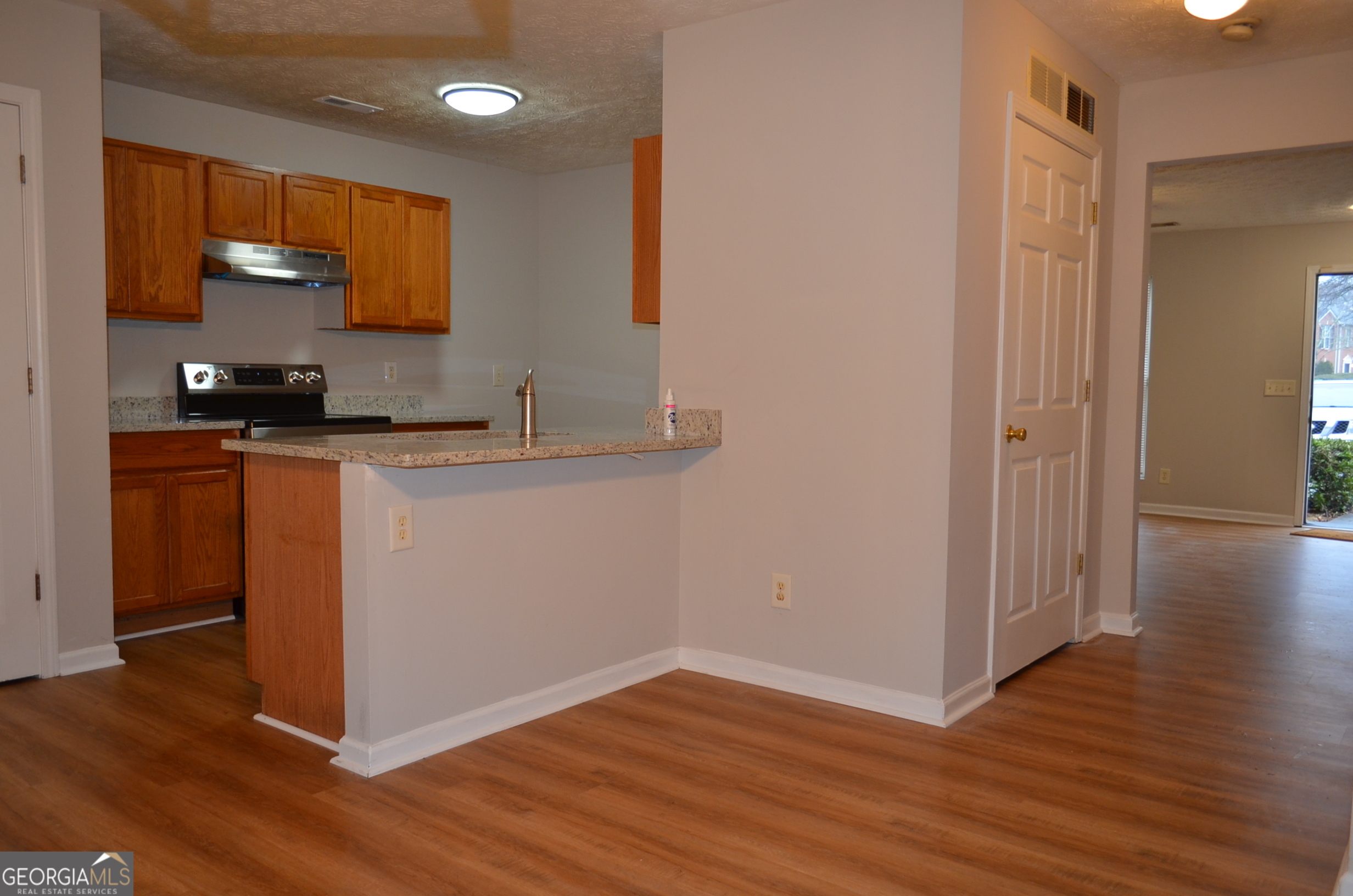 2722 Norfair Loop Lithonia, GA 30038 - Photo 8 of 25 a kitchen with wooden floor and a sink